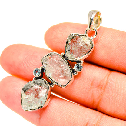 Rough aquamarine pendant in sterling silver with three rough stones and small blue round stones