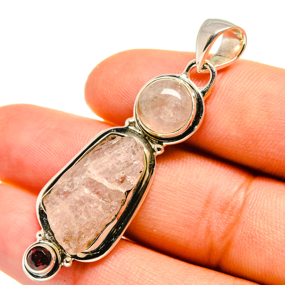 Sterling silver pendant with rough rose quartz and red garnet accents.