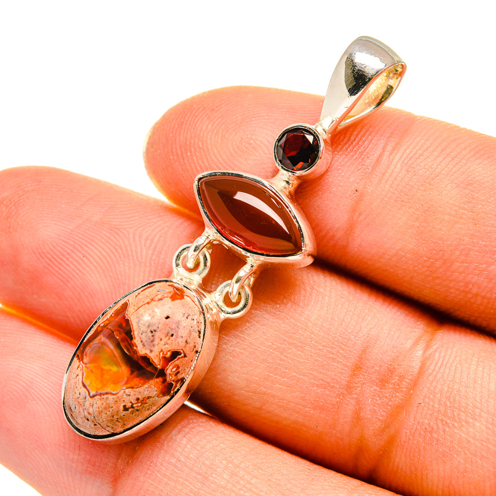 Sterling silver gemstone pendant with oval orange stone and dark round top, bail loop