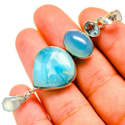 Sterling silver pendant with two heart-shaped aqua and blue stones and blue gem accents