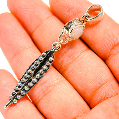 Sterling silver Ethiopian opal pendant close-up with oval cabochon and dark beaded frame
