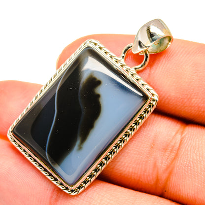 Banded agate pendant with dark rectangular stone in ornate sterling silver frame