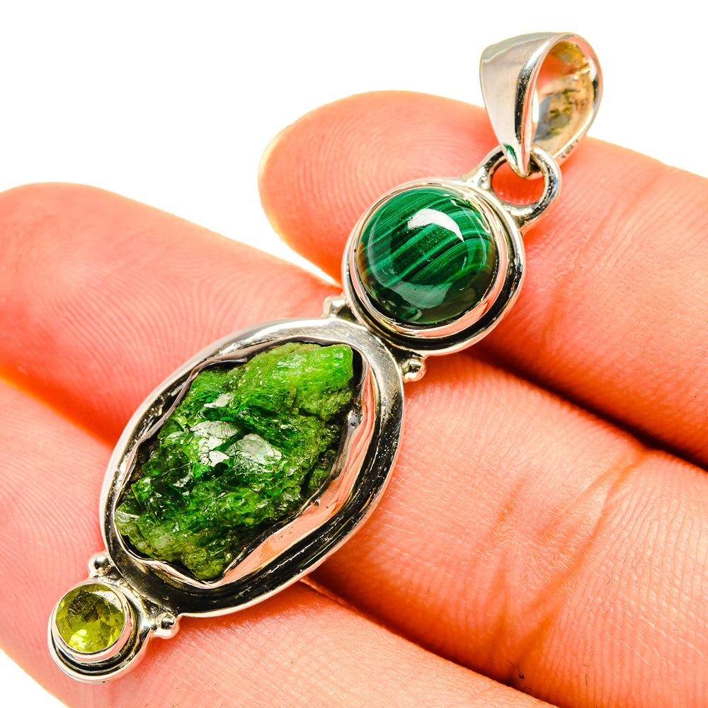 Green gemstone pendant with round bezel-set stone, oval textured stone, and small round accents