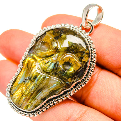 Labradorite skull pendant with bail; close-up of glossy yellow-green gemstone face