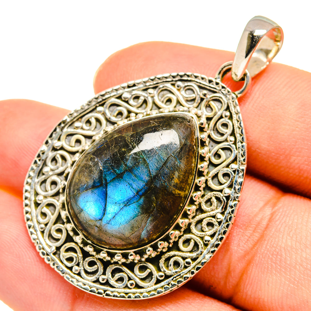 Labradorite pendant oval filigree sterling silver setting with dark stone and bright blue flash