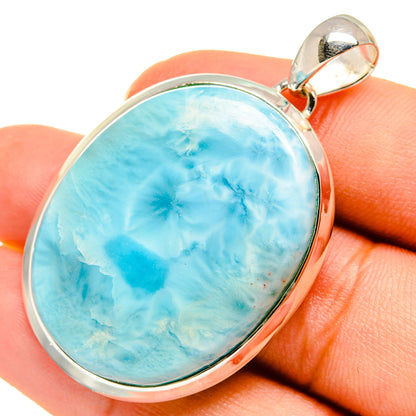 Oval larimar gemstone pendant in sterling silver with polished bail, close-up