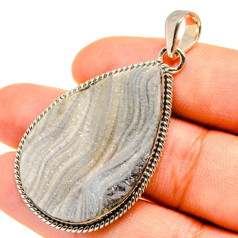 Teardrop drusy pendant in silver with gray and gold-toned stone, loop bail.