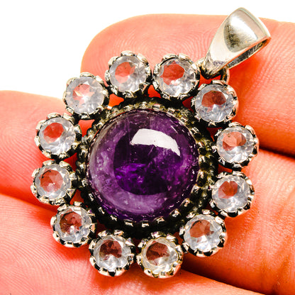 Amethyst and crystal pendant with purple round center, framed by clear stones in silver