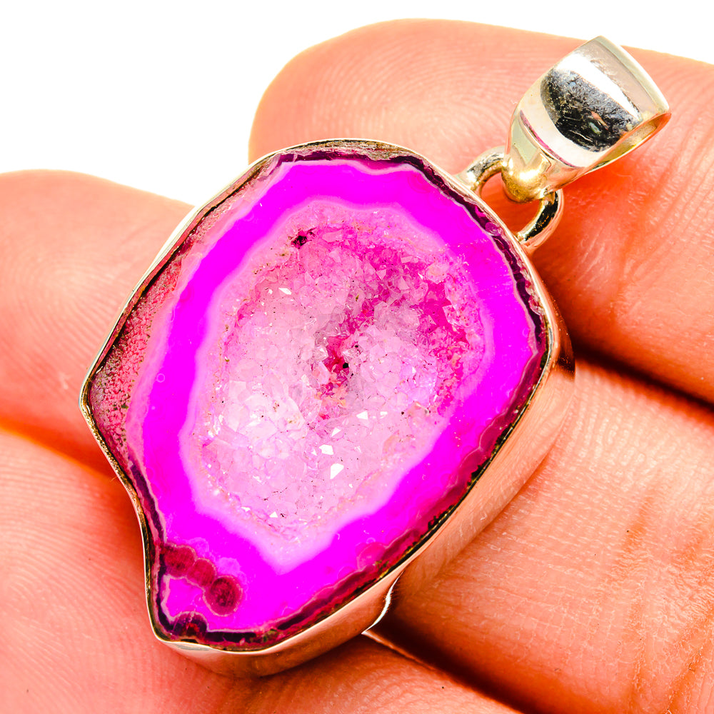 Pink agate druzy pendant on bail, pink geode center with gold-tone bezel in hand