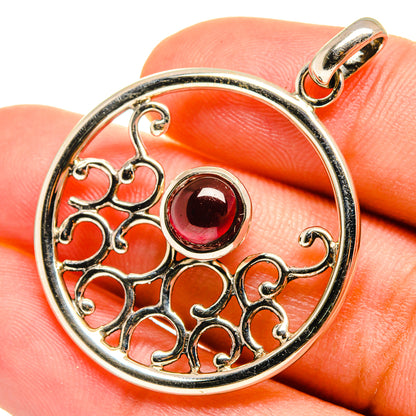 Sterling silver round garnet pendant with ornate openwork and dark red gemstone
