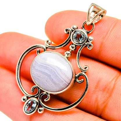 Sterling silver pendant with round blue-lavender cabochon and blue gemstone accents