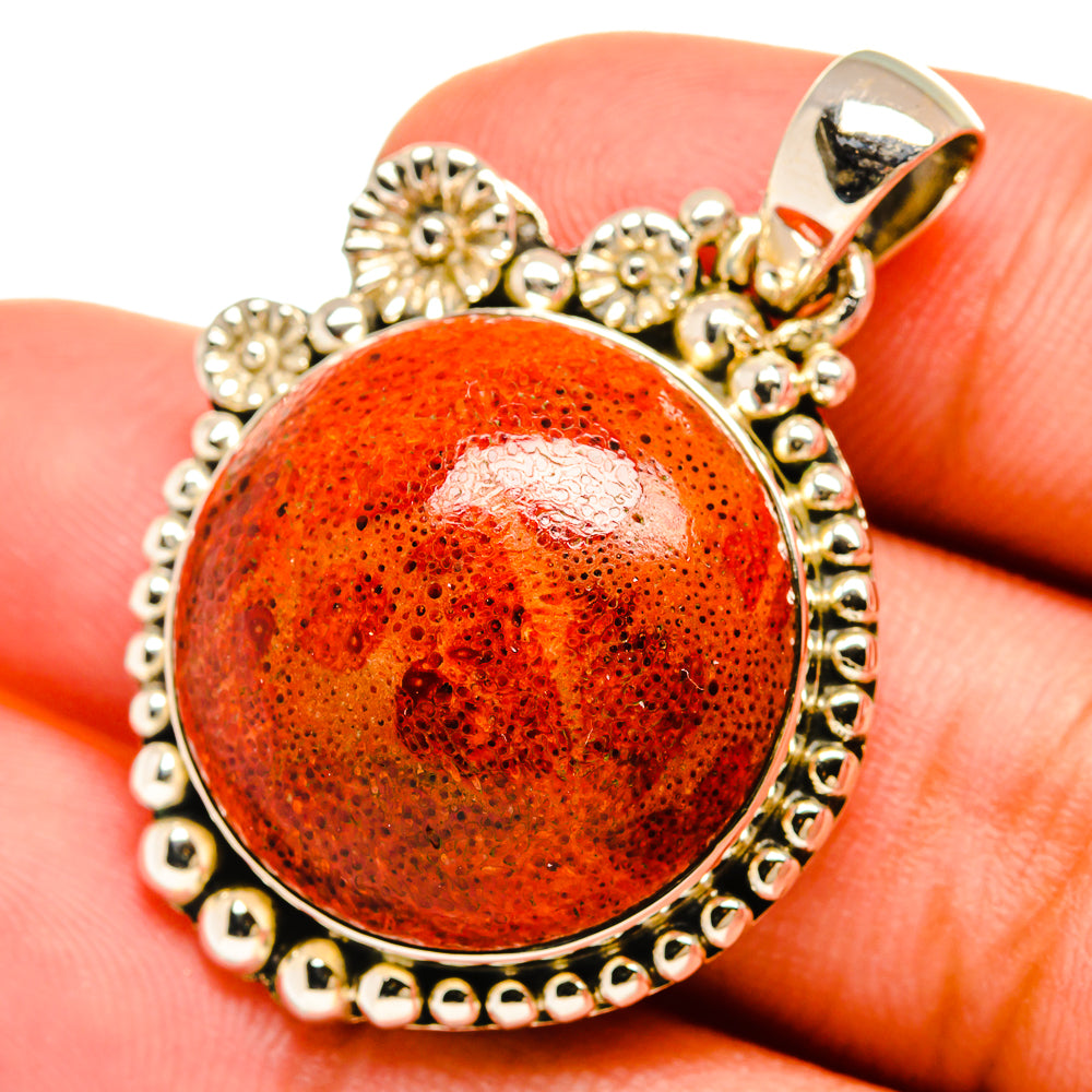 Coral orange round pendant with sterling silver beaded border and bail on finger