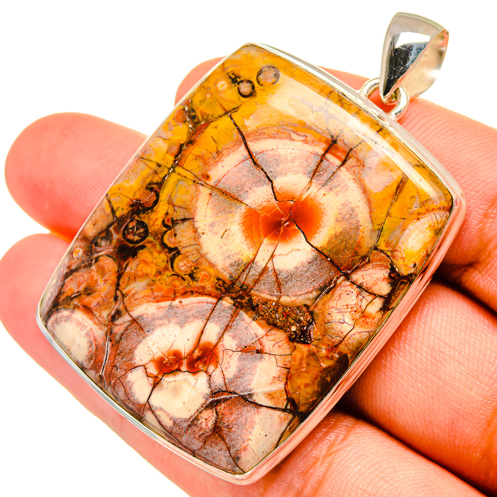 Jasper pendant with square silver bezel and round bail; orange-brown and cream cabochon stone