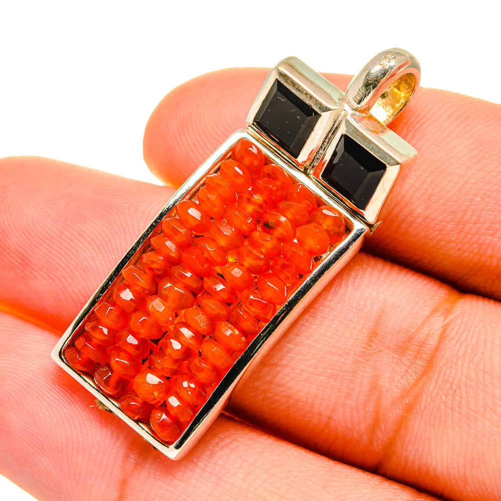 Carnelian bead pendant close-up, rectangular bezel with red/orange stones and silver frame