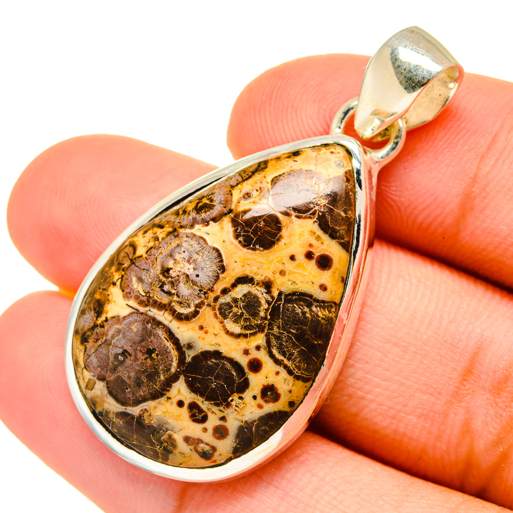 Poppy Jasper teardrop pendant close-up, 925 sterling silver frame around mottled amber stone