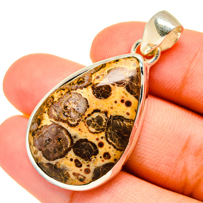 Poppy Jasper teardrop pendant close-up, 925 sterling silver frame around mottled amber stone