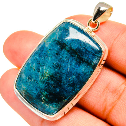 Apatite gemstone pendant in silver-tone bezel with oval blue stone and top bail