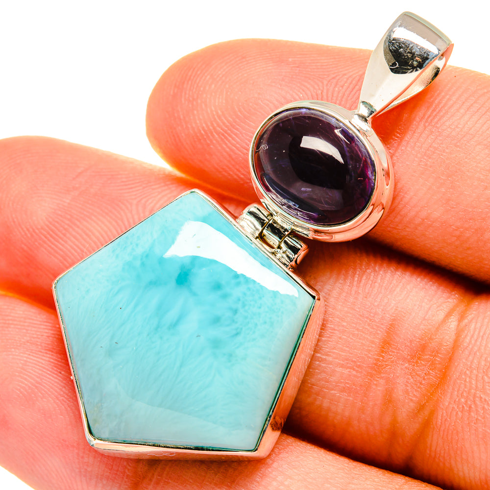Sterling silver pendant close-up with teal octagon and dark purple round gemstone