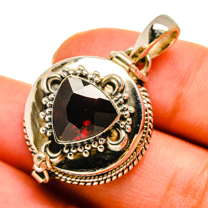 Garnet pendant with teardrop dark gemstone and red sparkle, ornate silver setting