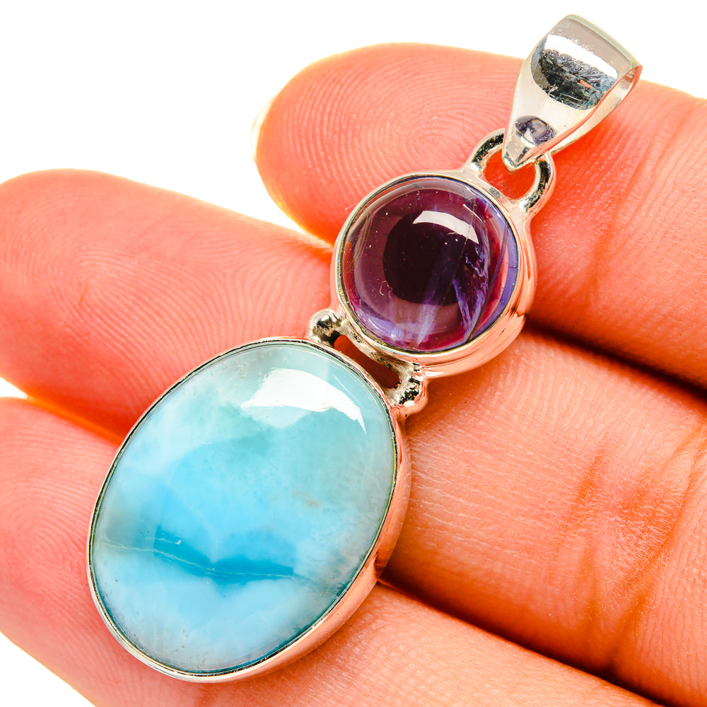 Sterling silver pendant close-up: oval Larimar with dark purple tanzanite cabochon