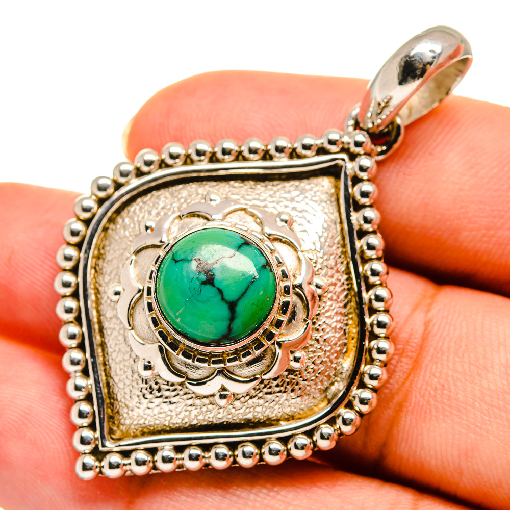 Sterling silver square pendant with green turquoise cabochon and ornate border