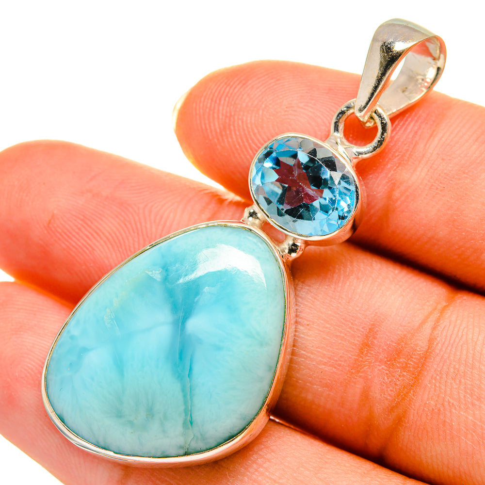 Sterling silver pendant close-up with oval blue larimar and round blue topaz bezel