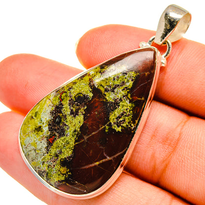 Teardrop cabochon pendant with mottled green-yellow and dark brown stone in silver