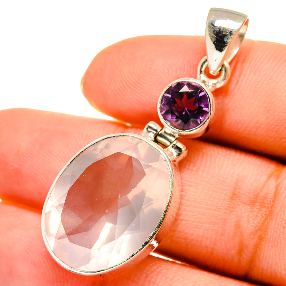 Amethyst and rose quartz pendant on hand, oval pink and round purple gemstones, gold bail