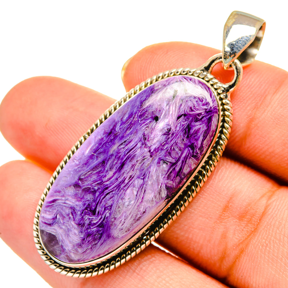 Charoite oval pendant with purple cabochon and silver tone bezel, sterling silver bail