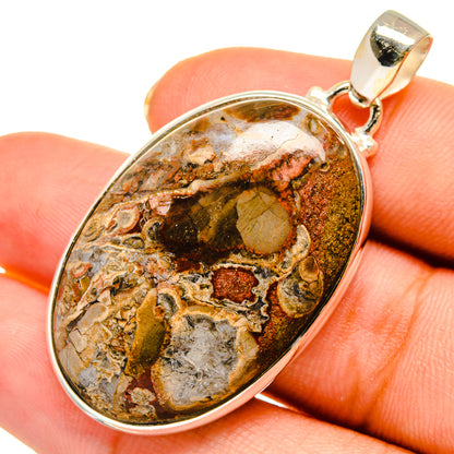 Oval rhyolite pendant with sterling silver bezel and bail; mottled tan, brown, and gray stone