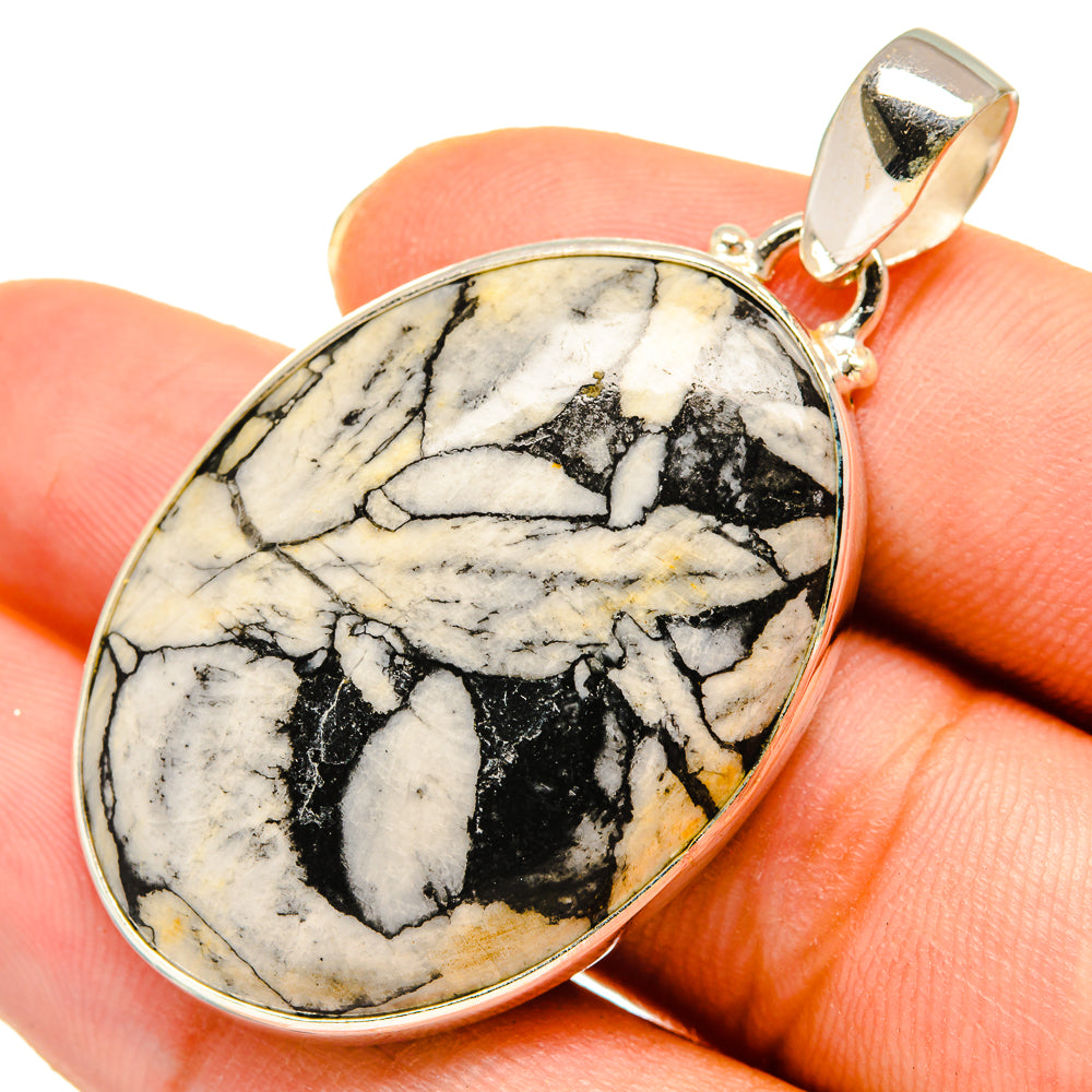 Close-up oval jasper pendant with black-and-white marbled stone and gold-tone bail