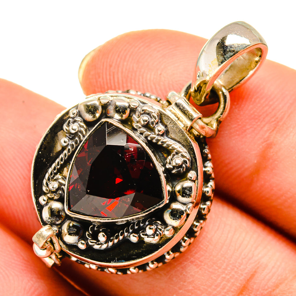 Sterling silver garnet pendant with oval red stone and ornate halo setting