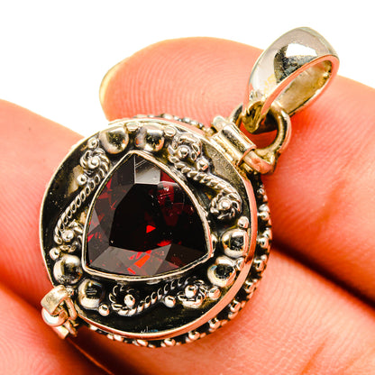 Sterling silver garnet pendant with oval red stone and ornate halo setting