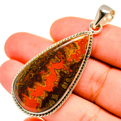 Close-up teardrop Moroccan agate pendant with red-orange mosaic stone and silver bail