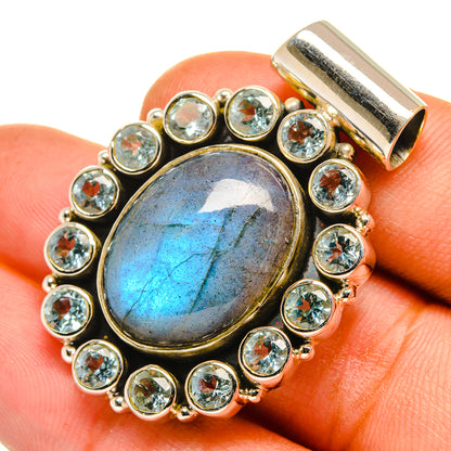 Labradorite pendant with oval blue flash stone, framed by round blue topaz settings