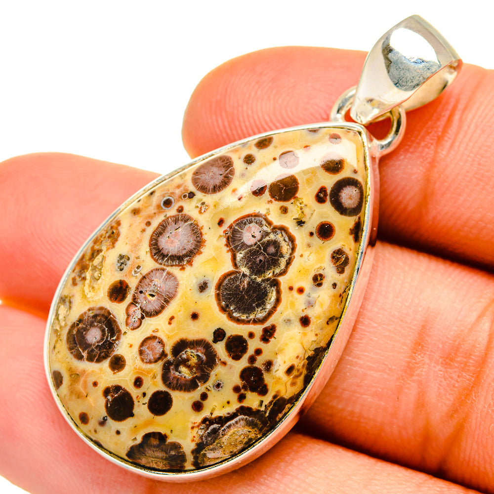 Poppy jasper teardrop pendant with silver bail, marbled orange and dark circular patterns
