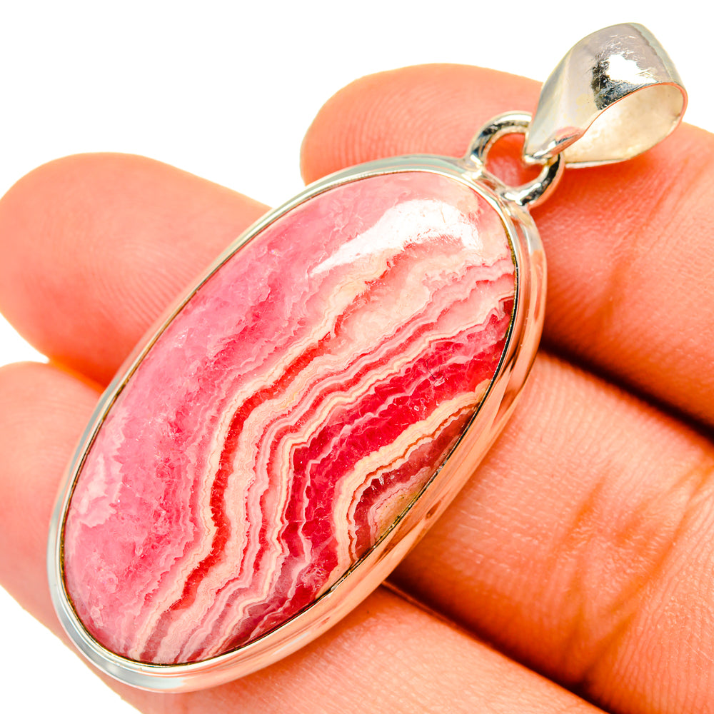 Oval rhodochrosite pendant, pink red banded stone with silver bail loop