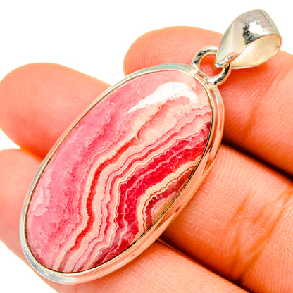 Oval rhodochrosite pendant, pink red banded stone with silver bail loop