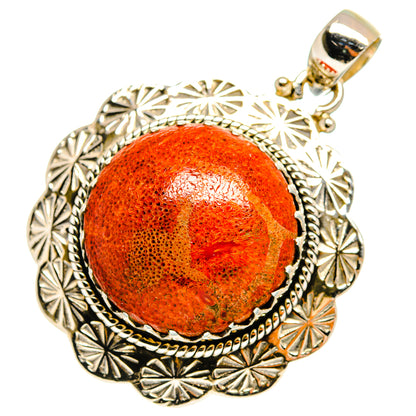 Sterling silver pendant with round orange sponge coral cabochon and ornate scalloped frame