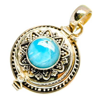 Sterling silver pendant with blue oval gemstone bezel, detailed border and loop bail