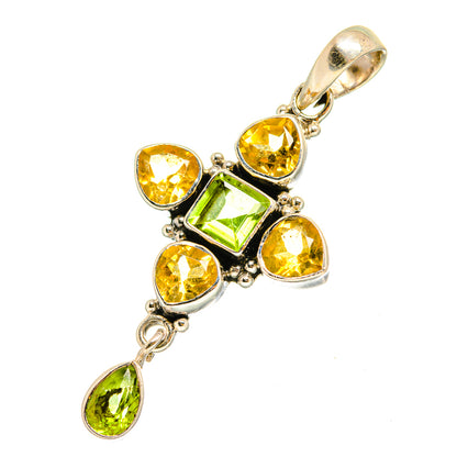 Sterling silver cross pendant with green and yellow faceted gemstones, bail at top