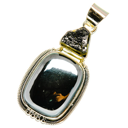 Black gemstone pendant with polished silver frame and textured top stone, oval setting