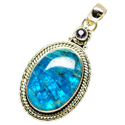 Oval blue gemstone pendant with ornate silver bezel and small purple accent stone