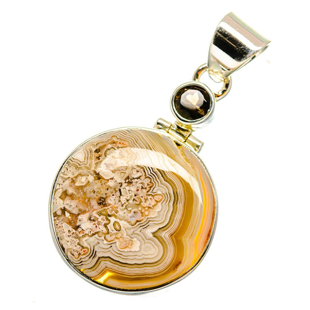 Round agate pendant with gold-tone bezel and dark gemstone, sterling silver bail