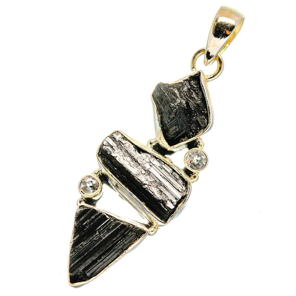 Sterling silver pendant with rough black stones and clear crystal details, open bail