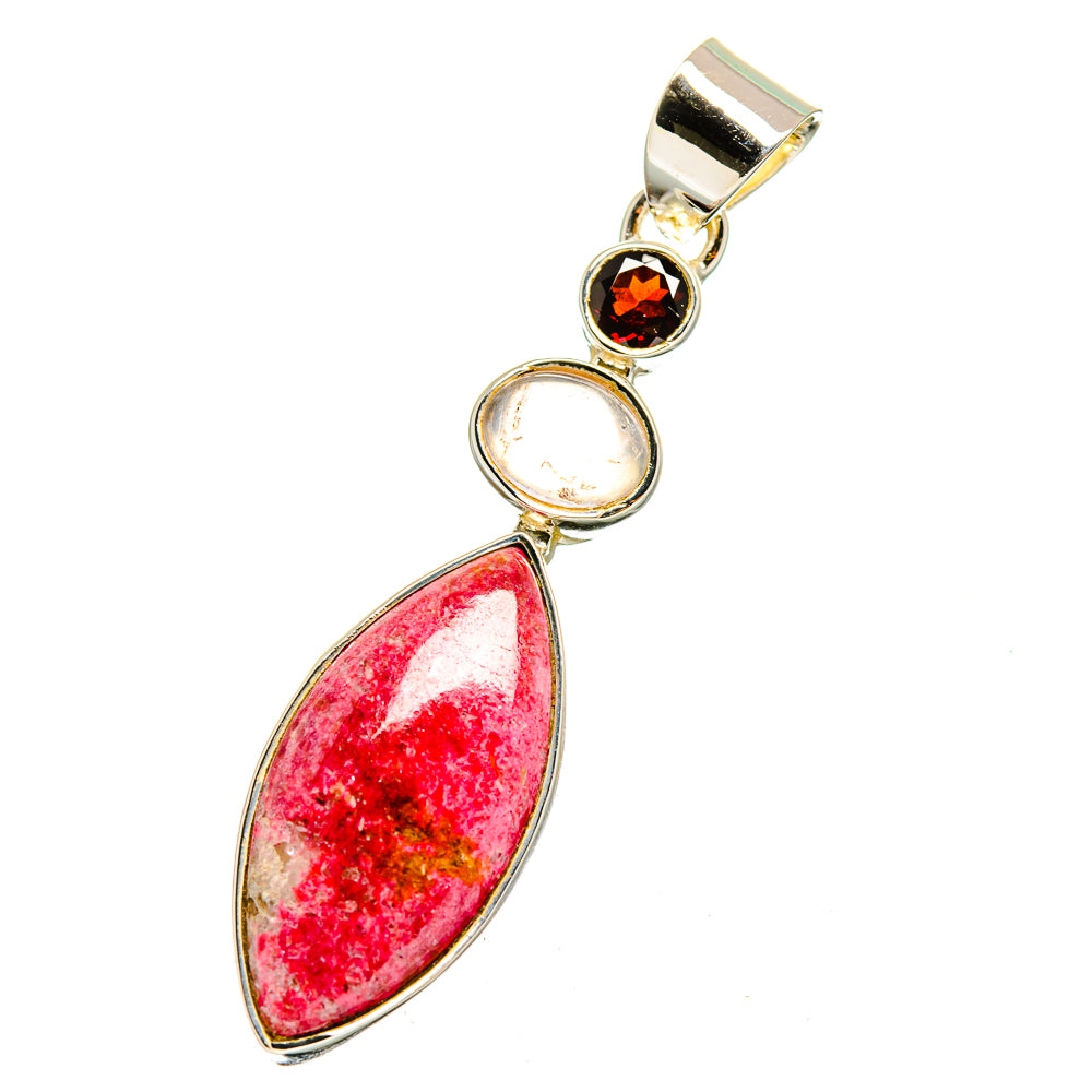 Gemstone pendant with red teardrop center stone and two round stones in silver-toned setting