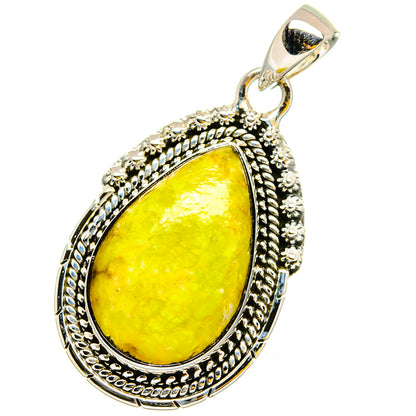 Sterling silver teardrop opal pendant with yellow-green stone and ornate border