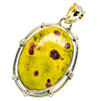 Oval yellow and purple-speckled atlantisite stone pendant with gold-toned bail