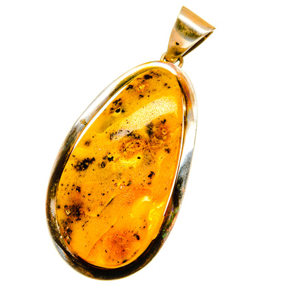 Baltic amber pendant with gold-toned amber teardrop set in silver bezel, bail at top