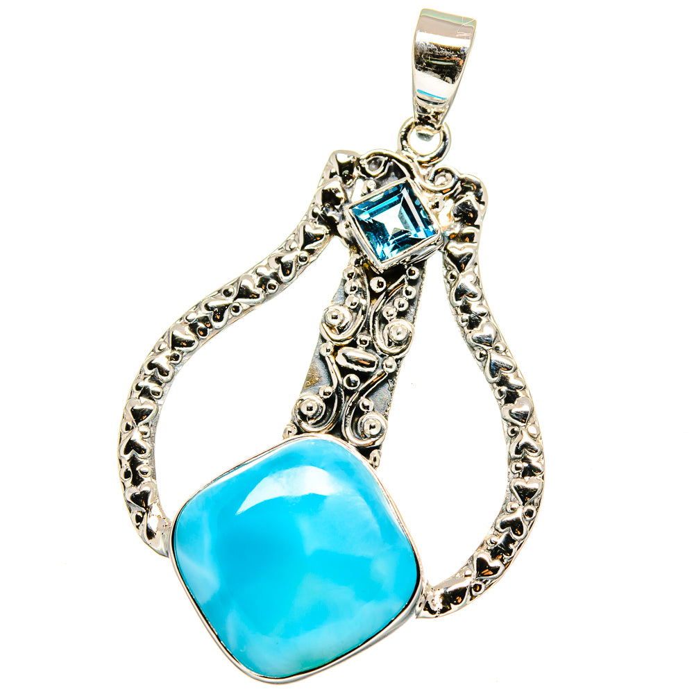 Sterling silver teardrop pendant with bright blue stone and decorative border.